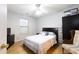 Cozy bedroom features a queen bed, a dresser with tv and an accent chair at 176 Darbys Crossing Ct, Hiram, GA 30141