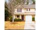 Charming townhome featuring a well-manicured lawn and an attached garage for convenient parking at 176 Darbys Crossing Ct, Hiram, GA 30141