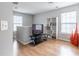 Living area with bright light, wood floors, shelving, and neutral walls create a spacious feel at 176 Darbys Crossing Ct, Hiram, GA 30141