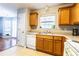 Functional kitchen featuring ample counter space, oak cabinets, and views to the backyard at 176 Darbys Crossing Ct, Hiram, GA 30141