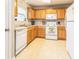 Well-maintained kitchen with oak cabinets, white appliances, and plenty of storage space at 176 Darbys Crossing Ct, Hiram, GA 30141