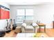 Cozy living room featuring hardwood floors, comfortable seating, and a large window for natural light at 176 Darbys Crossing Ct, Hiram, GA 30141