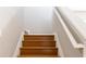 Staircase with wooden steps and white railings leading to the upper level of the home at 176 Darbys Crossing Ct, Hiram, GA 30141