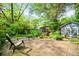 Backyard featuring a brick patio with lush landscaping, a small outbuilding, and seating area at 1941 Headland Dr, East Point, GA 30344