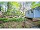 Private backyard featuring a swing, patio area, and a small outbuilding at 1941 Headland Dr, East Point, GA 30344