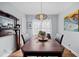Formal dining room with hardwood floors, a vintage mantel, designer lighting and ample seating at 1941 Headland Dr, East Point, GA 30344