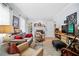 Bright living room boasts large windows, a fireplace, neutral tones, and stylish decor for relaxation at 1941 Headland Dr, East Point, GA 30344