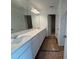 A spacious bathroom featuring a double sink vanity with white cabinets and a large mirror at 2093 Boxwood Se Cir, Conyers, GA 30094