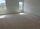 Bedroom with large windows, offering natural light and views of the surrounding neighborhood, awaiting personalization at 2093 Boxwood Se Cir, Conyers, GA 30094