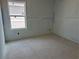 Bright bedroom with large window, offering a view of neighborhood; ready for flooring and personalization at 2093 Boxwood Se Cir, Conyers, GA 30094