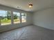 Bedroom with three large windows providing scenic outdoor views at 2093 Boxwood Se Cir, Conyers, GA 30094
