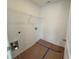 Laundry room equipped with utility connections, a built-in shelf, and durable flooring at 2093 Boxwood Se Cir, Conyers, GA 30094