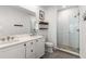 Modern bathroom with double sinks, sleek vanity, and glass-enclosed shower with neutral tile at 1265 Wright Se Ln, Atlanta, GA 30316