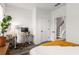 Clean bedroom featuring a desk, chair, and doorway to the staircase, light walls, and plant at 1265 Wright Se Ln, Atlanta, GA 30316