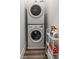 Efficient laundry area with stacked washer and dryer and a cart with cleaning supplies at 1265 Wright Se Ln, Atlanta, GA 30316