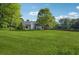 Expansive backyard with lush greenery and mature trees, offering a private outdoor space at 161 Brookfield Dr, Stockbridge, GA 30281