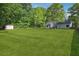 Lush backyard with storage shed, offering a private outdoor space at 161 Brookfield Dr, Stockbridge, GA 30281