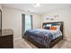 Cozy bedroom featuring a comfortable bed, soft carpet, and ample natural light from the window at 161 Brookfield Dr, Stockbridge, GA 30281