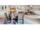 Spacious dining room with a table and six chairs, with a clear view to both the kitchen and living room at 161 Brookfield Dr, Stockbridge, GA 30281