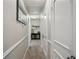 Neutral hallway features clean white trim and doors leading to carpeted spaces within the home at 161 Brookfield Dr, Stockbridge, GA 30281