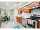 Bright kitchen featuring wood cabinets, modern appliances, and a view of the breakfast nook at 161 Brookfield Dr, Stockbridge, GA 30281