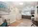 Open-concept living room with wood floors, cozy sofa, stone fireplace, and bright natural light at 161 Brookfield Dr, Stockbridge, GA 30281
