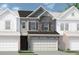 Charming townhome featuring stone accents, a two-car garage, and a welcoming facade at 210 Bastian Dr # 109, Villa Rica, GA 30180