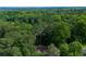 An aerial shot of the home in a wooded area. Atlanta skyline is visible in the distance at 2674 Skylane Dr, Marietta, GA 30062