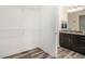 Bright bathroom with a dark vanity, granite countertop, and wire shelving in an adjacent closet space at 2674 Skylane Dr, Marietta, GA 30062
