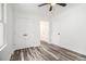 Bright bedroom with plank flooring, a ceiling fan, and white trim at 2674 Skylane Dr, Marietta, GA 30062