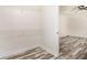 Walk-in closet with wire shelving, adjacent to a bedroom with neutral paint and plank flooring at 2674 Skylane Dr, Marietta, GA 30062
