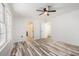 Bright bedroom with hardwood floors, ceiling fan, and white walls at 2674 Skylane Dr, Marietta, GA 30062