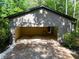 Exterior shot of the carport attached to the home, surrounded by lush greenery at 2674 Skylane Dr, Marietta, GA 30062