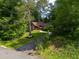 Exterior rear of the home showcasing a wooden deck and natural landscaping at 2674 Skylane Dr, Marietta, GA 30062