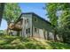 Two-story house with gray siding, a small elevated deck, and a well-maintained lawn surrounded by trees at 2674 Skylane Dr, Marietta, GA 30062