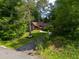 Home nestled among the trees with a manicured front yard at 2674 Skylane Dr, Marietta, GA 30062