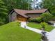 Charming home featuring a well-manicured lawn, landscaped yard, and quaint white gravel walkway at 2674 Skylane Dr, Marietta, GA 30062