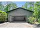 Detached garage with an open door and a door leading into the fenced backyard of the property at 2674 Skylane Dr, Marietta, GA 30062