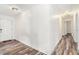 Bright hallway with laminate floors, neutral walls, and a decorative front door at 2674 Skylane Dr, Marietta, GA 30062