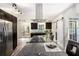 Well-lit kitchen featuring granite countertops, stainless steel appliances, and plank flooring at 2674 Skylane Dr, Marietta, GA 30062
