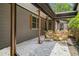 Cozy covered patio area featuring stone ground cover and a charming wicker seating area at 2674 Skylane Dr, Marietta, GA 30062