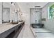 Spacious bathroom with dual sinks, a freestanding tub, and luxurious marble tiling at 292 Highway 279, Fayetteville, GA 30214