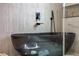 This modern bathroom features a sleek, dark soaking tub and contemporary fixtures at 292 Highway 279, Fayetteville, GA 30214