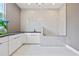 Laundry room features a convenient pet washing station with sleek, white cabinets at 292 Highway 279, Fayetteville, GA 30214