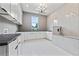 Bright laundry room with ample counter space, white cabinets, and stylish chandelier at 292 Highway 279, Fayetteville, GA 30214
