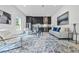 Living room with modern decor, an open kitchen, and stylish furnishings at 292 Highway 279, Fayetteville, GA 30214