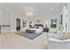 Spacious main bedroom with an elegant chandelier, large windows, and seating area at 292 Highway 279, Fayetteville, GA 30214