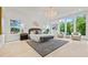 Bright main bedroom featuring a statement chandelier and large windows at 292 Highway 279, Fayetteville, GA 30214