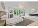 Sunlit main bedroom boasts a fireplace, modern decor, and serene outdoor views at 292 Highway 279, Fayetteville, GA 30214