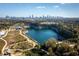 Scenic aerial view featuring a quarry lake and walking trails with the city skyline in the distance at 976 Arthur Nw Ln, Atlanta, GA 30318